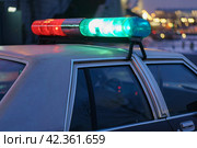 Police patrol at night. City street in winter. Harassment of the offender. To protect and serve. American car, 80s. Offense against the law. Police forces. Defocused cityscape as background. Стоковое фото, фотограф YuryKara / Фотобанк Лори