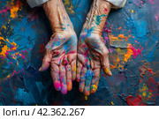 Background for the Holi holiday, voluminous and airy colored powder on the palms of the hands of an elderly old woman and empty space for design. Стоковое AI-изображение, AI-художник Мария Фадеева / Фотобанк Лори