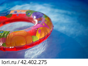 Colorful ring floating in a refreshing blue swimming pool. Стоковое фото, фотограф Александра Баранова / Фотобанк Лори