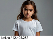 Portrait of frowning cover girl kid model 6 year old in white t-shirt expression emotion, angry looking at camera. Scowl child posing at black, studio shot. Kids emotional concept. Copy ad text space. Стоковое AI-изображение, AI-художник Aleksandr Golubev / Фотобанк Лори