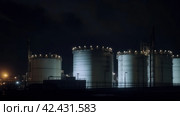 Huge oil refinery tank at night, ominous, detailed, dark, dim lighting, glowy, sinister ,    Generative AI. Стоковое AI-изображение, AI-художник Анна Кривицкая / Фотобанк Лори