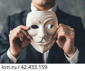 Man Holding Mysterious Mask. Стоковое AI-изображение, AI-художник Кирилл Черезов / Фотобанк Лори