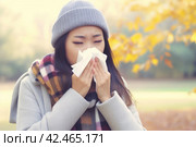 Woman tissue blowing in park. Generate Ai. Стоковое AI-изображение, AI-художник Иван Рябоконь / Фотобанк Лори