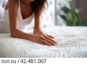 Woman hand touching soft mattress bed. Generate Ai. Стоковое AI-изображение, AI-художник Иван Рябоконь / Фотобанк Лори