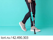 Man injured leg using crutches. Generate Ai. Стоковое AI-изображение, AI-художник Иван Рябоконь / Фотобанк Лори