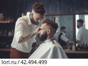 Barber giving haircut in salon. Generate ai. Стоковое AI-изображение, AI-художник Иван Рябоконь / Фотобанк Лори