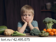 Little boy expressing disgust to healthy food. Generate ai. Стоковое AI-изображение, AI-художник Иван Рябоконь / Фотобанк Лори