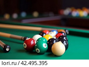 Many colorful billiard balls and cue on green table. Generate Ai. Стоковое AI-изображение, AI-художник Иван Рябоконь / Фотобанк Лори