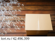 One open cardboard box with bubble wrap on wooden. Generate Ai. Стоковое AI-изображение, AI-художник Иван Рябоконь / Фотобанк Лори