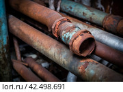 Rusty old damaged heating system pipe. Generate ai. Стоковое AI-изображение, AI-художник Иван Рябоконь / Фотобанк Лори