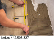 The process of laying floor tiles on the SVP Base, Tile Leveling System. Стоковое фото, фотограф Evgenii Predibailo / Фотобанк Лори