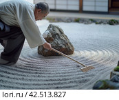 Zen Garden Maintenance by a Monk. Стоковое AI-изображение, AI-художник Кирилл Черезов / Фотобанк Лори