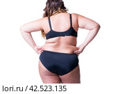 Plus size model in black lingerie, overweight female body, fat woman with cellulitis on buttocks isolated on white background. Стоковое AI-изображение, AI-художник Станислав Тарко / Фотобанк Лори