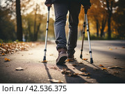 Struggling Man injured leg using crutches. Generate Ai. Стоковое AI-изображение, AI-художник Иван Рябоконь / Фотобанк Лори