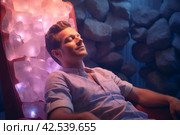 Receptive Man during crystal healing session in therapy room. Generate Ai. Стоковое AI-изображение, AI-художник Иван Рябоконь / Фотобанк Лори
