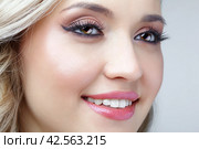 Beauty portrait of smiling blonde woman. Female Woman wearing earrings with rhinestones. Стоковое фото, фотограф Сергей Пристяжнюк (Serg Zastavkin) / Фотобанк Лори
