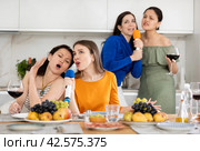 Cheerful slightly tipsy women singing with microphones at home karaoke. Стоковое фото, фотограф Яков Филимонов / Фотобанк Лори