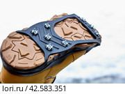 Ice traction cleats fit securely on any shoe or boot and allow you to stride easily on ice and snow-covered pavement and gravel. Стоковое фото, фотограф Владимир Григорьев / Фотобанк Лори