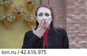 Mime young woman protects her face with hands imitates an imaginary fear or fright. Страх, испуг. Стоковое видео, видеограф EStarodubov / Фотобанк Лори