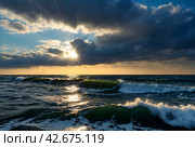 Atmospheric scenery Dramatic Baltic sea, waves and water splashes on breakwaters. Nature north cloudscape on coast ocean. Environment with fickle weather, climate change. Stormy, abstract backgrounds. Стоковое AI-изображение, AI-художник Aleksandr Golubev / Фотобанк Лори