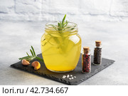 Homemade beef bone and vegetable broth with turmeric seasoning in a glass jar for storage and carrying. Healthy food with collagen and amino acids. Copy space. Стоковое фото, фотограф Глущенко Елена / Фотобанк Лори