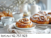 Cinnamon buns on a Scandi table. Image for cafe menu, Banner. Стоковое AI-изображение, AI-художник Ирина Ручушкина / Фотобанк Лори