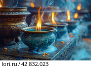 Metal bowls with decorative patterns from which smoke and flames rise, probably ritual or aromatherapy lamps. Стоковое AI-изображение, AI-художник Анна Кривицкая / Фотобанк Лори