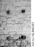 An old roughly plastered, sooty brick wall with metal squares. Стоковое фото, фотограф Сергей Фролов / Фотобанк Лори