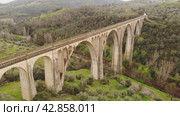 Scenic drone view of green spring hilly landscape with Guadalupe viaduct built in early 20th century, planned as railway bridge, Spain. Стоковое видео, видеограф Яков Филимонов / Фотобанк Лори