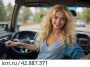 A beautiful blonde girl at an auto sound competition. Car music. Subwoofers, amplifiers, acoustics. Car audio system. Стоковое AI-изображение, AI-художник Александр Поташев / Фотобанк Лори