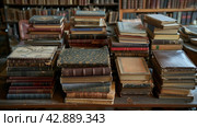 A lot of old books in a book store, flea market, old books. Стоковое AI-изображение, AI-художник Анна Кривицкая / Фотобанк Лори