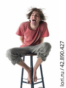 Joyful Man on Stool Making Funny Face. Стоковое AI-изображение, AI-художник Кирилл Черезов / Фотобанк Лори