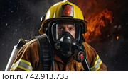 A male firefighter in a special outfit against the background of flames and clouds of black smoke. A rescuer on fire. A firefighter extinguishes the fire. Стоковое AI-изображение, AI-художник Photojuli / Фотобанк Лори