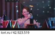 Young girl is unable to open a bottle of wine for her birthday. Стоковое видео, видеограф Strunov David / Фотобанк Лори