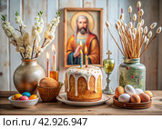 Orthodox Easter. Easter cake, painted eggs, icons, faces of saints, flowers, church candles and Easter decor on a wooden table in an old village house. Стоковое AI-изображение, AI-художник Photojuli / Фотобанк Лори
