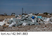 Pile of construction waste in front of an unfinished building. Стоковое фото, фотограф Вербицкая Светлана / Фотобанк Лори