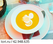 Pureed vegetable soup served with boiled eggs in bowl with spoon and glass of wine. Стоковое фото, фотограф Яков Филимонов / Фотобанк Лори