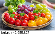 A bowl of assorted fruits and vegetables on a wooden table, AI. Стоковое фото, фотограф Сергей Старуш / Фотобанк Лори