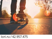 A person riding a skateboard on a sidewalk. Ideal for urban sports concepts. Стоковое AI-изображение, AI-художник Ярославский Максим / Фотобанк Лори