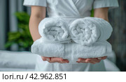 The woman is clutching towels with her fingertips in one hand. Стоковое AI-изображение, AI-художник Юрий Поздников / Фотобанк Лори