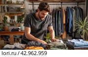 a man is folding clothes in a clothing store. Стоковое AI-изображение, AI-художник Юрий Поздников / Фотобанк Лори