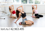 Female dancer mastering floorwork during high heels dance routine. Стоковое фото, фотограф Яков Филимонов / Фотобанк Лори