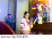 Tween children solving riddles in quest room., toned image. Стоковое фото, фотограф Яков Филимонов / Фотобанк Лори