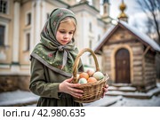 Happy bright Easter. Christianity. Portrait of a three-year-old girl in a Russian folk dress and shawl with a wicker basket with Easter eggs in her hands against the background of an Orthodox church. Стоковое AI-изображение, AI-художник Photojuli / Фотобанк Лори