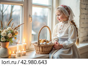 Happy bright Easter. Christianity. Portrait of a three-year-old girl in a Russian folk dress and shawl with a wicker basket with Easter eggs in her hands against the background of an Orthodox church. Стоковое AI-изображение, AI-художник Photojuli / Фотобанк Лори