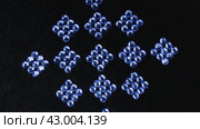 Вращение квадратиков из синих страз. Вид сверху. Красивая геометрия. Rotation of the squares of blue rhinestones. View from above. Стоковое видео, видеограф Александр Собко / Фотобанк Лори