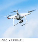 Unmanned aerial vehicle UAV drone quadrocopter or quadrotor DJI with camera in action in sky and shoots video around it from bird's eye view (2019 год). Редакционное фото, фотограф А. А. Пирагис / Фотобанк Лори