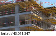 Moscow March 22 2024, Construction site with tower crane. House and buildings construction. Hotel apartments construction. Housing renovation, real estate. Crane on formwork in Built environment. Редакционное фото, фотограф Скрипачев Антон / Фотобанк Лори