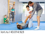 Woman student, with help of male teacher, completes neutralization of opponent. Стоковое фото, фотограф Яков Филимонов / Фотобанк Лори