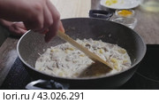 The cook prepares vegetables with cream and combines them using a spatula. Стоковое видео, видеограф Strunov David / Фотобанк Лори